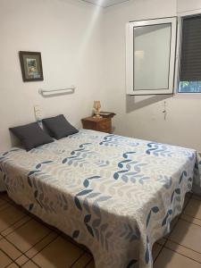 a bedroom with a bed with a blue and white comforter at Villa Irene in Gandía