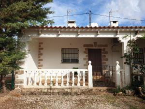 a white house with a white fence in front of it at La Caseja Rural in Ossa de Montiel