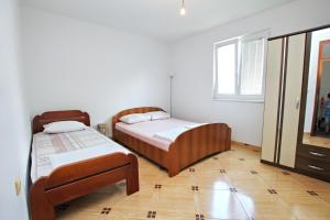 sypialnia z 2 łóżkami i oknem w obiekcie Petra flat apartment w Barze