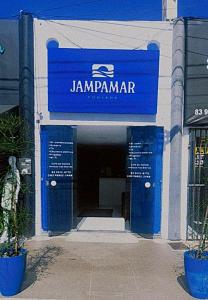 a blue sign on the front of a building at Jampa Mar Pousada in João Pessoa