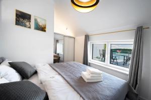 Posteľ alebo postele v izbe v ubytovaní Apartamenty Z Widokiem Na Mazury Jezioro Juno