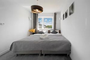 Posteľ alebo postele v izbe v ubytovaní Apartamenty Z Widokiem Na Mazury Jezioro Juno