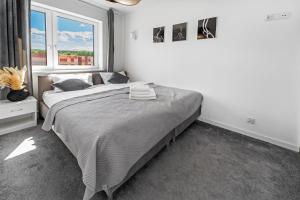 Posteľ alebo postele v izbe v ubytovaní Apartamenty Z Widokiem Na Mazury Jezioro Juno