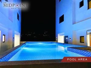 a large swimming pool in a building at The Midpoint Residences - Studio Unit in Cebu City