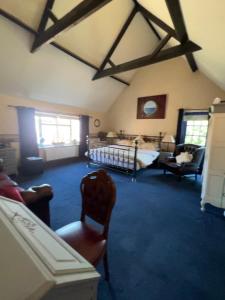 a bedroom with a bed and a chair in a room at The Coach House in Retford