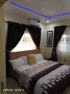 a bedroom with a bed with a blue light above it at Luxury 2 bed apartment. 