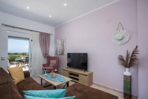 a living room with a couch and a tv at Thalia's House in Pastida