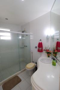 a bathroom with a shower and a toilet and a sink at Casa da Manu Búzios in Búzios