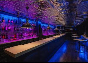 a bar with purple lights in a room at Legends Accomodation in Broadstairs