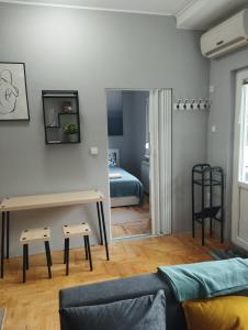 a living room with a couch and a bedroom at Apartman Aleksandra in Smederevo