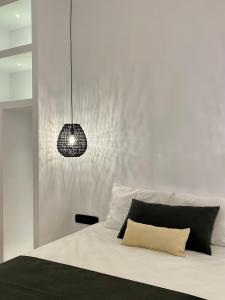 a bedroom with a bed and a pendant light at Asteras Cozy Stay in Naousa
