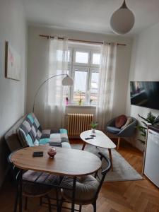 a living room with a table and a couch at Apartmán Pražská in Jablonec nad Nisou