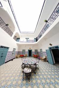 a room with a table and chairs and a ceiling at Hostel BE 20 in Marrakesh
