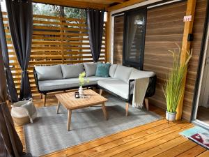 a patio with a couch and a table at Mobile Homes MaLu in Biograd na Moru