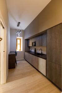 a kitchen with black counters and a counter top at Seven Winds Suite in Naples +23 photos