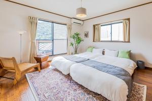 a bedroom with a large bed and a large window at mei Hakone in Hakone