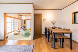 a dining room and living room with a table and chairs at mei Hakone in Hakone