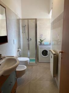 a bathroom with a shower sink and a washing machine at Pisana 247 St Peter in Rome