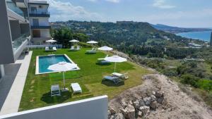 a pool with umbrellas and chairs on top of a building at Aquarama Pool Apartments in Ixia