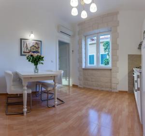 a kitchen and dining room with a table and chairs at Chic Apartment in Center in Split