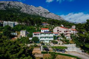 a town on a hill with a mountain in the background at Apartments Tina in Brela