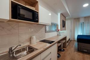 a kitchen with a sink and a microwave at Apartments Tina in Brela