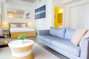 a living room with a couch and a bed at Center Stage- Downtown Parking Pool Hot Tub in Miami