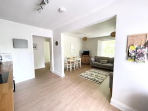 a living room with a couch and a table at Lincombe Court Apartment Wellswood Torquay in Torquay