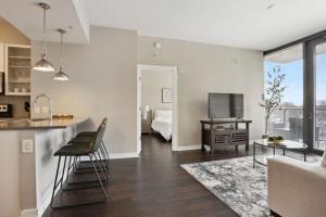 a kitchen and living room with a couch and a table at Piedmont Park 2 bdrm in Atlanta