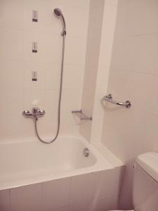 a bathroom with a shower and a tub and a toilet at SKY AND SEA APARTMENT in Xylokastro