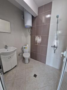 a bathroom with a toilet and a sink at Arapya Apartments in Tsarevo