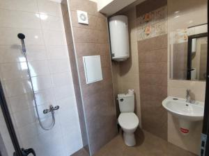 a bathroom with a toilet and a sink at Arapya Apartments in Tsarevo