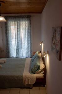 a bedroom with a bed and a window with lights at Vaso Alykanas Studios in Alikanas