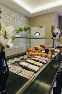 a buffet line with many different types of food at Bourbon Curitiba Hotel & Suítes in Curitiba