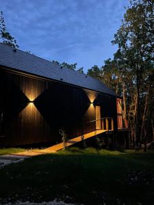 a barn with lights on the side of it at Wabi sabi lodge&spa in Turenne