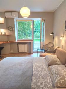 a bedroom with a bed and a large window at Great view apartaments near Lavra in Kyiv