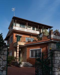 a house with a balcony on top of it at VILLA MAVI in Formia