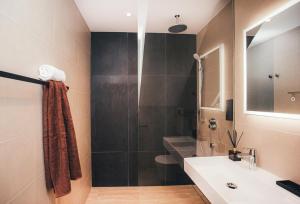 a bathroom with a sink and a shower at WakeMālpils brīvdienu mājas in Mālpils