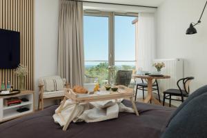 a living room with a coffee table in front of a window at Pinea 718 SeaView in Pobierowo
