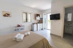 Un dormitorio con una cama con toallas. en Villa Gallieco, en Noto