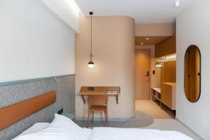 a bedroom with a bed and a desk and a table at Evripides Hotel in Athens
