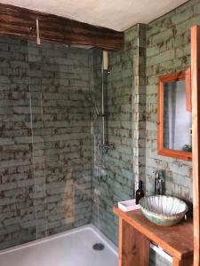 a bathroom with a bath tub and a sink at Ynyswen bed & breakfast in Nantgaredig