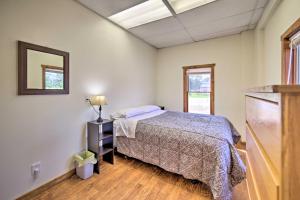 a bedroom with a bed and a mirror on the wall at Eben Junction Vacation Rental - 2 Mi to Ice Caves! in Chatham