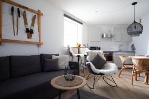 a living room with a couch and a table and a kitchen at Ferienappartement Winterberg - Bikepark um die Ecke in Winterberg