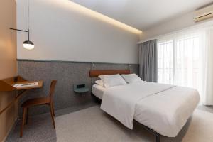 a hotel room with a bed and a desk and a bed sidx sidx at Evripides Hotel in Athens