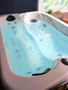 a bath tub with blue water in it at Chalet Puerto Escondido in Telde