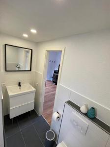 a bathroom with a sink and a mirror at Haffkrug Beach Bungalow in Scharbeutz