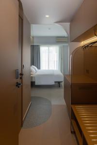 a bedroom with a white bed and a window at Evripides Hotel in Athens