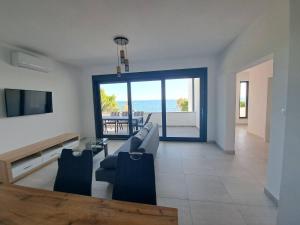 a living room with a view of the ocean at Villa Leptirić in Vir
