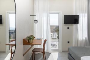 a bedroom with a bed and a desk with a desk at Evripides Hotel in Athens